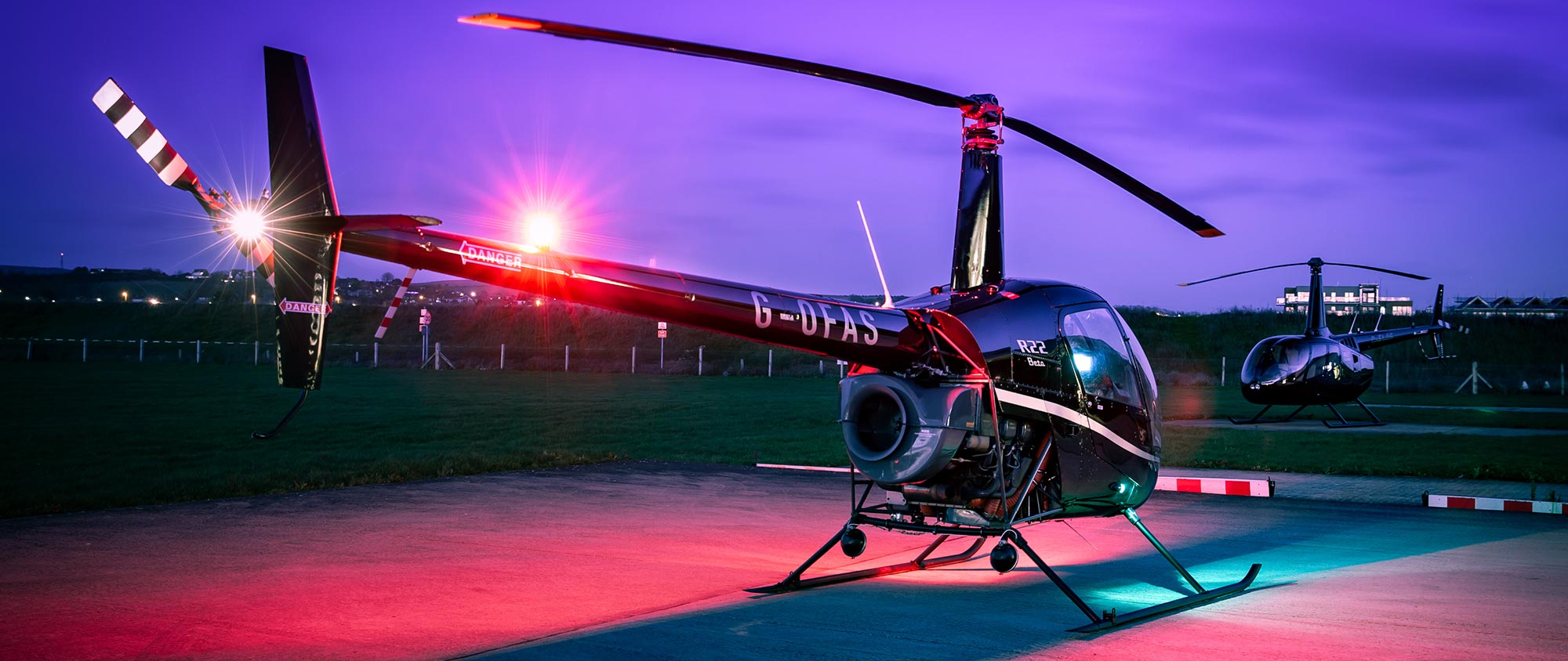 Robinson R22 helicopter with R66 in background